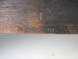 a close up of a piece of wood with writing on it
