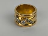 a close up of a gold ring with a diamond on it