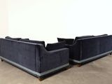 pair of black velvet sofas with chrome legs and arms