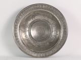 a silver plate that is sitting on a white surface