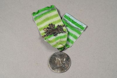 a small medal with a coin on a table