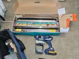 a box of tools sitting on the floor next to a box of tools