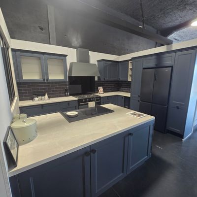 a kitchen with a sink, stove, and refrigerator in it