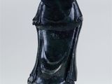 a black statue of a woman with a hat on her head