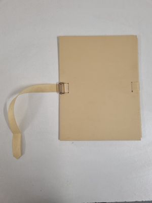 a piece of paper that has been tied up to a piece of paper