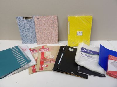 many different types of binders and books on the table