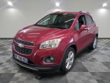 the red chevrolet trax is parked on a checkered floor