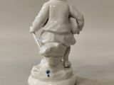porcelain figurine of a boy with a basket of flowers