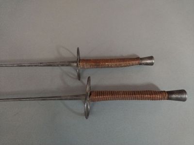two swords that are on the table together