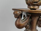 a statue of a woman holding a tray with a cup on it