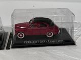 a small red car in a clear case on a table