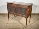 an old wooden cabinet on a tiled floor
