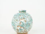 a blue and white vase sitting on a white surface