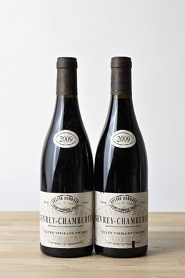 deux bouteilles de vin posées l'une à côté de l'autre sur une table en bois