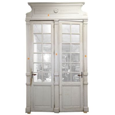 a white double door with a window above it