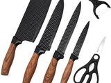 three knives and a pair of scissors are sitting next to each other