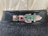 a woman wearing a belt with a buckle on it