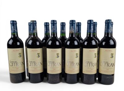 six bottles of wine are lined up in a row on a white surface
