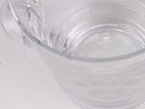 a glass cup with a spoon in it on a table