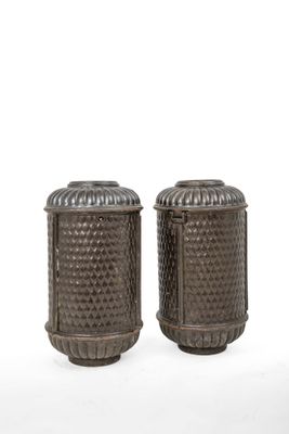 a pair of metal salt and pepper shakers on a white background