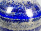 a picture of a blue and white marble ball on a white surface