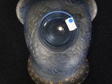 a blue glass vase with a bear head on it