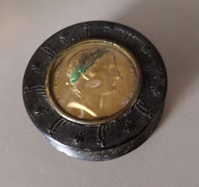a coin with a face on it sitting on a table