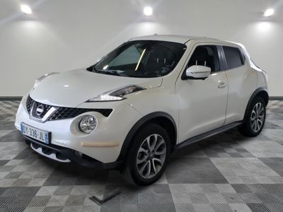 a picture of a white nissan juke suv parked in a garage
