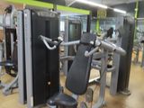 a gym room with a row of machines in it