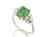 an emerald and diamond three stone ring
