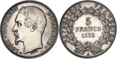 a close up of a coin with a man ' s face on it