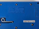 a close up of a blue electrical device on a white surface