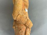 an ancient statue of a man with a hat on his head