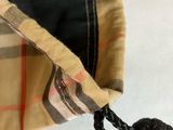 a small bag with a knot hanging from it ' s side