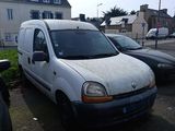 a white van parked in a parking lot next to other cars