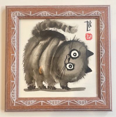a painting of a cat that is hanging on the wall
