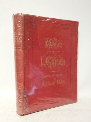 un vieux livre rouge posé sur une table blanche