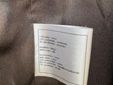 a close up of a label on a brown jacket