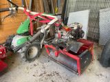 a lawn mower that is sitting in a garage