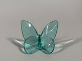 a glass butterfly that is sitting on top of a table