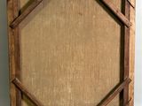 an old picture frame with a picture of a person in it
