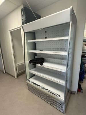 an empty refrigerator in the middle of a room