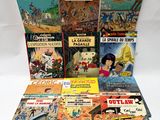 a bunch of comics sitting on top of each other on a table