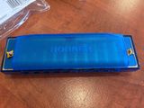 a blue harmonica sitting on a table next to other items