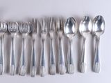 a lot of silver spoons and spoon spoons on a table