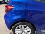 a blue car that is parked in a parking lot