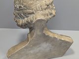 a close up of a bust of a man on a table