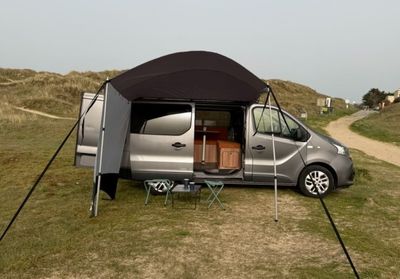 an image of a camper van parked in the grass