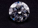 a close up of a diamond on a black surface
