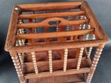 an old wooden magazine rack with beads on it